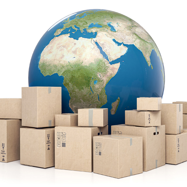 A stack of packages in front of a globe
